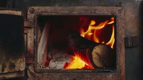 Wood Log Burning Inside Rusty Stove - Fire Close-Up Through Open Door Stock Footage 327986324