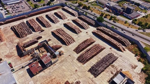 Wood material storage area seen from above near a busy road Video stock 342602625