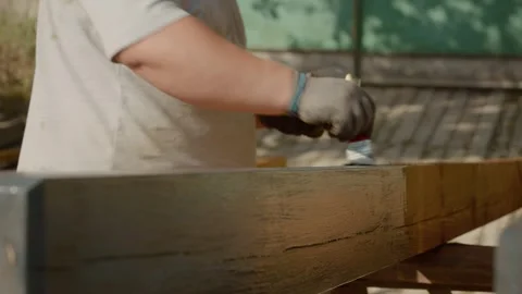 Wood painting process shown step by step in a sunny outdoor setting Video stock 324663247