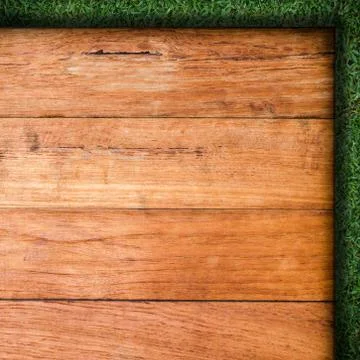 Wood plank on natural green grass field Stock Photos