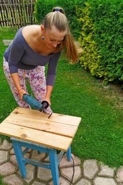 Wood processing. emphasizing wood texture. woman working with wood outdoors Stock Photos