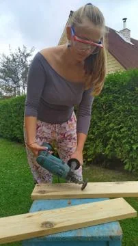 Wood processing. emphasizing wood texture. woman working with wood outdoors Stock Photos