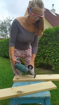 Wood processing. emphasizing wood texture. woman working with wood outdoors Stock Photos
