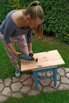 Wood processing. emphasizing wood texture. woman working with wood outdoors Stock Photos