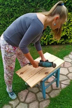 Wood processing. emphasizing wood texture. woman working with wood outdoors Stock Photos