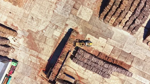 Wood processing at a lumber yard in a busy industrial area during daylight hours Stock Footage 343564641