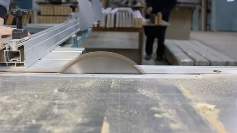 Wood processing machine operates in carpentry workshop, man cuts wooden board Stock Footage 124923197