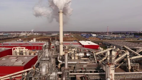 Wood processing plant pollutes the air with smoke coming from the pipe. Stock Footage 120640997