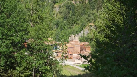 Wood processing plant saw mill stacked timber logs stored outdoor mountain .. Stock Footage 341415262