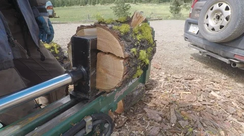 Wood splitter machine at work, track in to close up then close top view Stock Footage 91757003