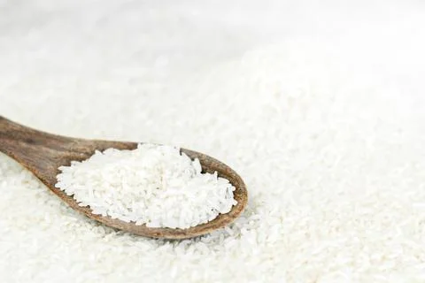 Wood spool and white grain rice Stock Photos