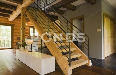Wood Stairway With Wrought Iron Railings In Modern Eastern White Pine Log Cabin