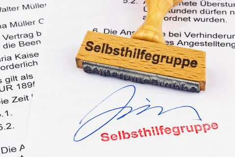 Wood stamp on the document: self-help group Stock Photos