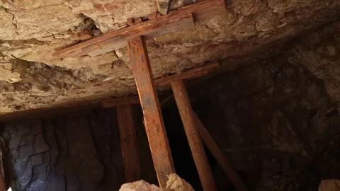 Wood Stulls Holding Up Ceiling from Inside Abandoned Mine - Shallow DOF Stock Footage 246202754