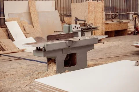 Wood surface planer machine in carpentry workshop Stock Photos