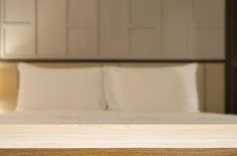Wood table top and Abstract Blurred image bedroom. Can be used for display or Stock Photos