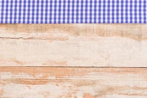 Wood table top background texture, with rustic blue tablecloth Stock Photos