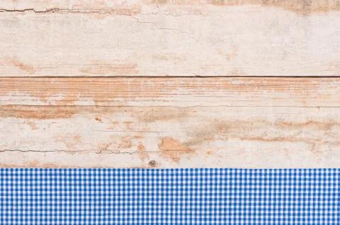 Wood table top background texture, with rustic blue tablecloth Stock Photos