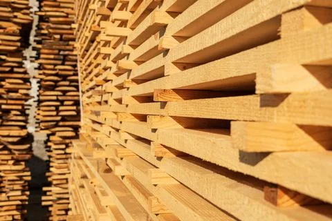 Wood timber in the sawmill. Stack of lumber. Sawmill, wood processing. Stock Photos