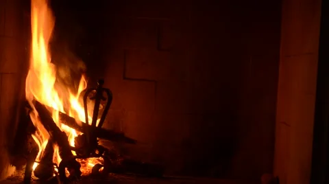 Wood trunks in the fire in the fireplace with flame lit Video stock 57342961