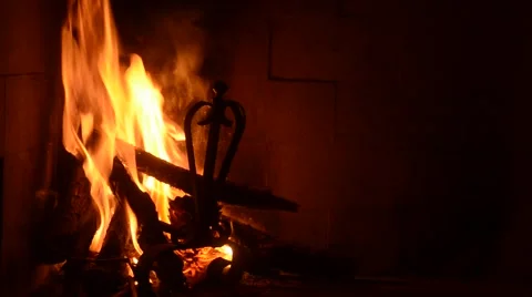 Wood trunks in the fire in the fireplace with flame lit Video stock 57346853