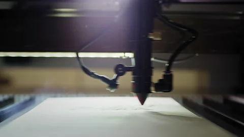 Woodburning. Industrial laser is cutting a pattern on a plywood sheet and moving Stock Footage 142016417