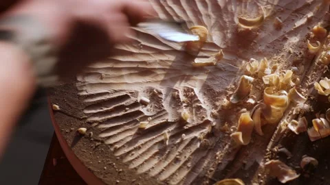 A woodcarver processes a pine board with a chisel. carpenter makes carving Stock Footage 148272542