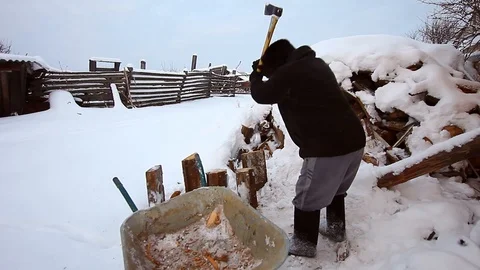 Woodcutter cuts the tree with an ax, the chips are flying Stock Footage 87239783
