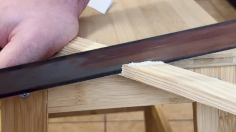 Woodcutting using hand tools craftsman demonstrates cutting technique plywood Stock Footage 309533703