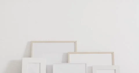 Wooden and white frames with copy space on white background and white wall Stock Footage 331208365