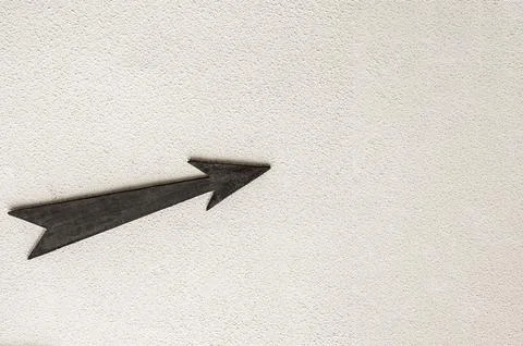 Wooden arrow pointer to the right up on light background Stock Photos