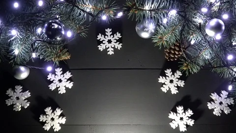 Wooden background arranged with pine branches at the top, with lights and toys 스톡 동영상 99057833