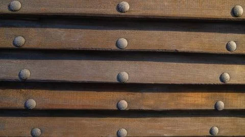 Wooden background with nails rivets, horizontal boards close-up Stock Photos
