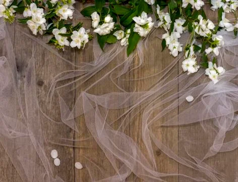 Wooden background with a white grid and fresh white jasmine flowers Stock Photos