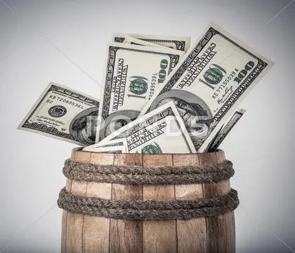 Wooden barrel with hundred dollar bills Stock Photos