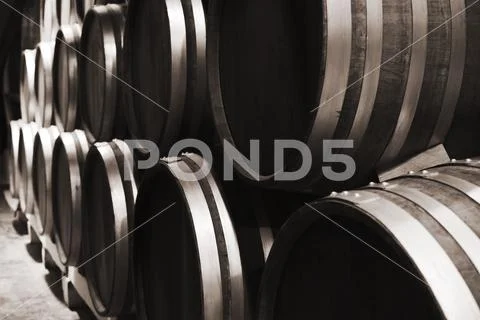Wooden barrels in winery, close up photo Stock Photos
