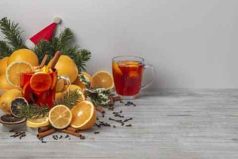 Wooden basket with oranges and lemons punch in glass cup spices Christmassy Stock Photos