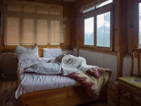 Wooden bed in the mountain hotel, tours (2 day tour) to Tiger Leaping Gorge of Stock Photos