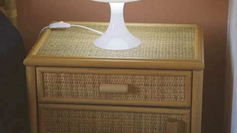 Wooden bed table with a lamp Stock Footage 86751182