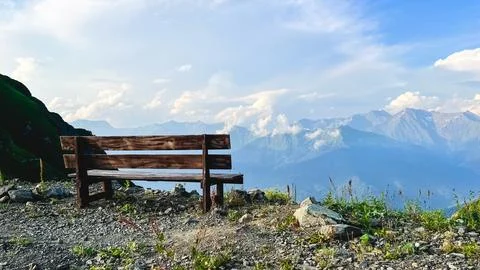 Wooden bench overlooking dramatic Caucasus mountain landscape Stock Photos