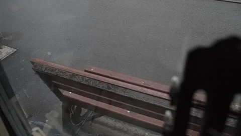 Wooden bench in the rain, view from the window Stock Footage 306147868