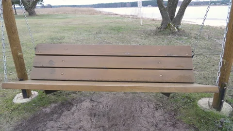 A wooden bench on the side of the playground Stock Footage 138970917