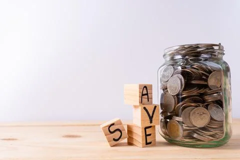 Wooden block stack with save word and jar full of coins isolated grey backgro Stock Photos