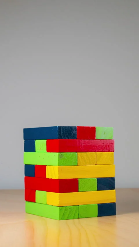 Wooden block tower under construction in timelapse speed. vertical video Stock Footage 262758911