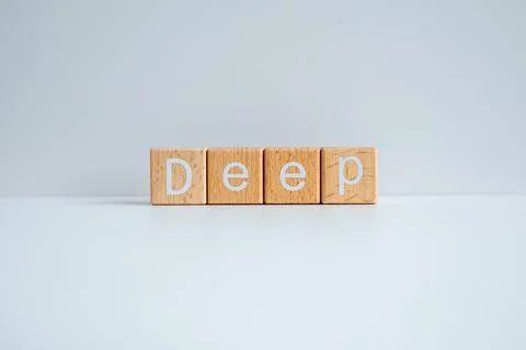 Wooden blocks form the text "Deep" against a white background. Stock Photos