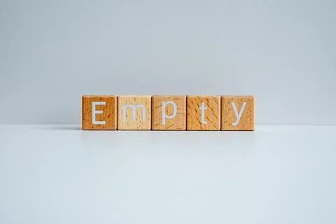 Wooden blocks form the text "Empty" against a white background. Stock Photos