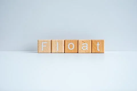 Wooden blocks form the text "Float" against a white background. Stock Photos