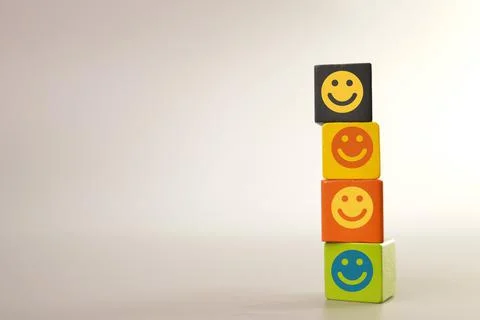 Wooden blocks with happy face symbols. Customer evaluation and satisfaction c Stock Photos