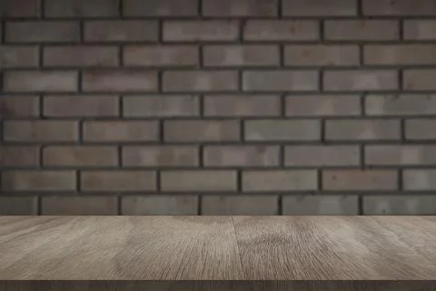 Wooden board empty table in front of light brick wall background Foto stock