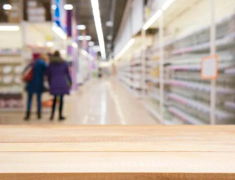 Wooden board empty table over blur in supermarket 스톡 사진